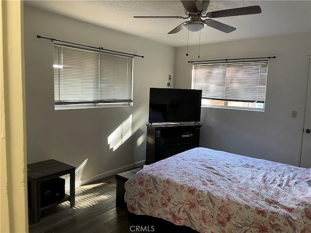 bedroom featuring ceiling fan and dark wood-type flooring