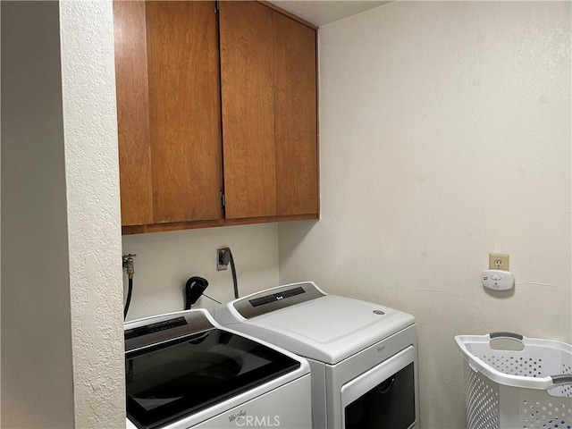 laundry room with cabinets and separate washer and dryer