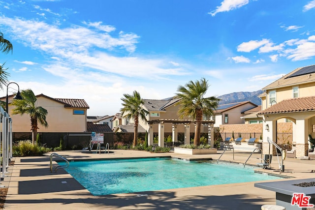 view of pool featuring a mountain view and a patio