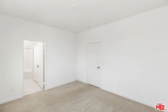 empty room with light colored carpet