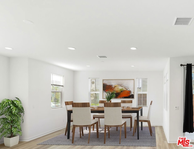 dining space featuring light wood-type flooring