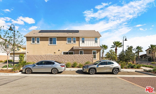 view of front of property featuring solar panels