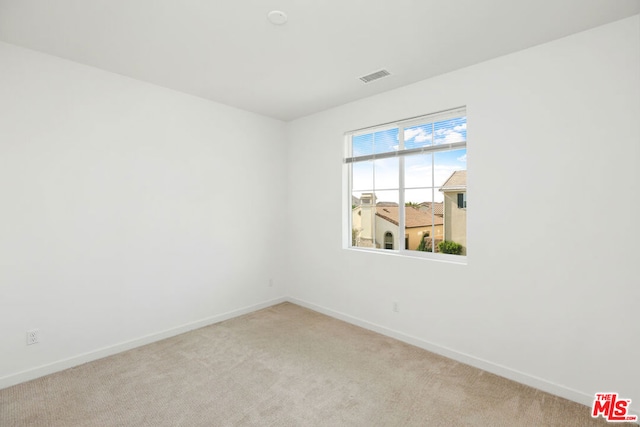 empty room featuring light carpet