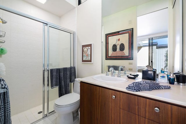 bathroom with vanity, toilet, and a shower with shower door