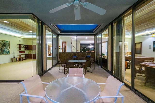 sunroom / solarium featuring ceiling fan