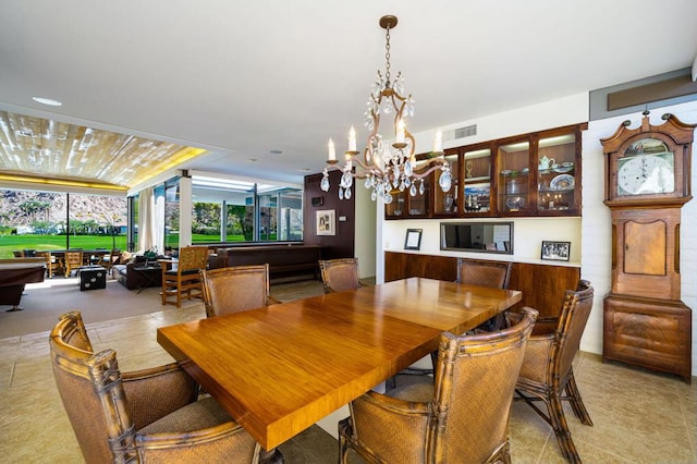 dining area with a chandelier and billiards