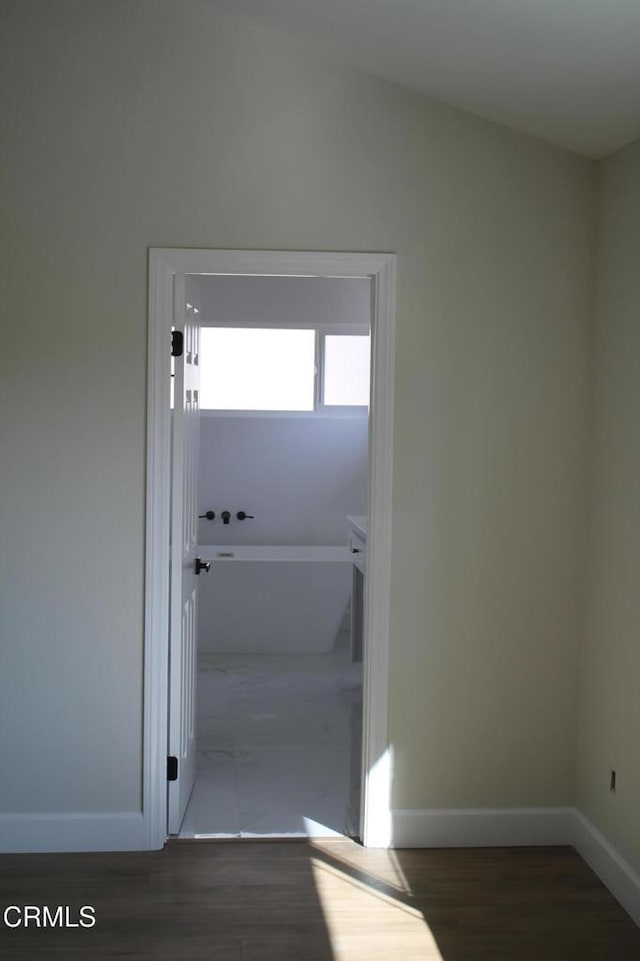 entryway with dark hardwood / wood-style floors and vaulted ceiling