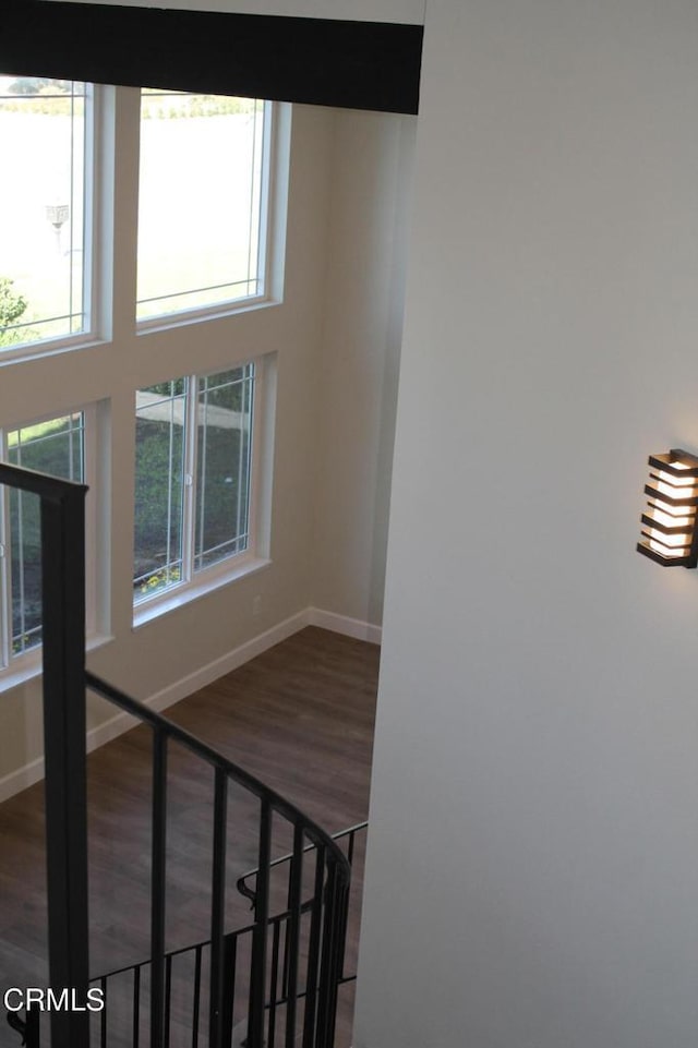 stairway featuring hardwood / wood-style floors and a towering ceiling