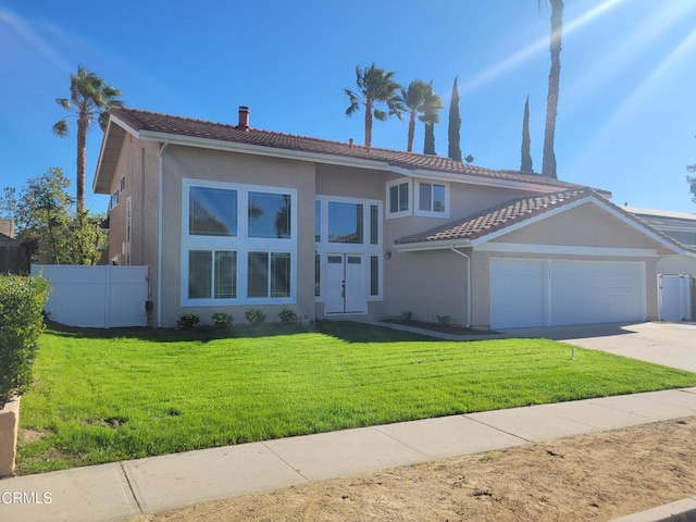 view of front of property with a front lawn and a garage