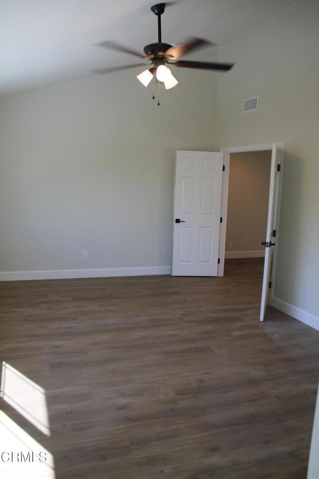 unfurnished room with ceiling fan, dark wood-type flooring, and a high ceiling