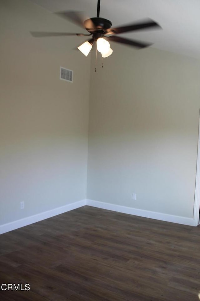 spare room with ceiling fan and dark hardwood / wood-style flooring