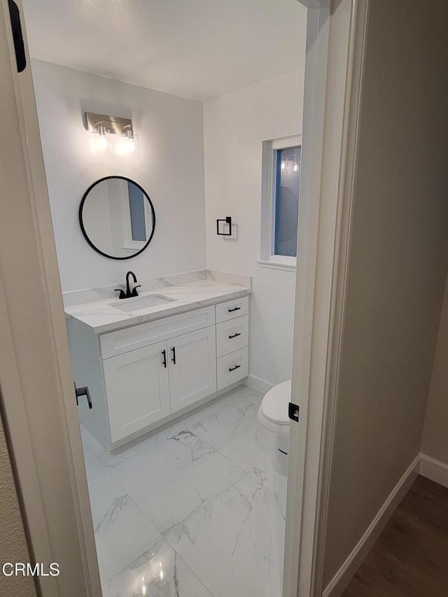 bathroom with vanity and toilet