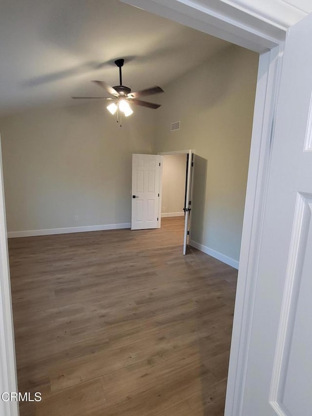 spare room featuring hardwood / wood-style flooring and ceiling fan