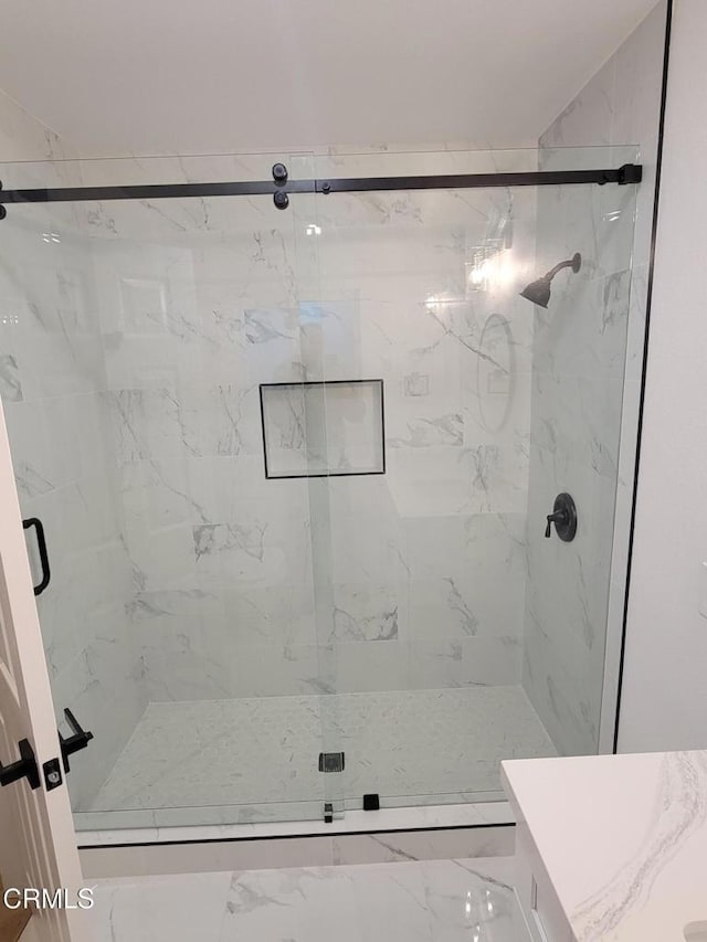 bathroom with vanity and a shower with shower door