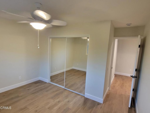 unfurnished bedroom with ceiling fan, light hardwood / wood-style flooring, and a closet