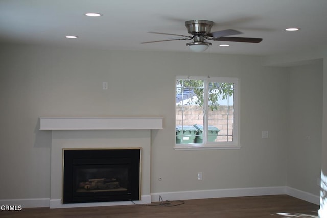 unfurnished living room featuring dark hardwood / wood-style floors and ceiling fan