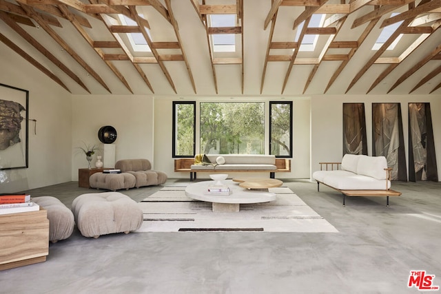 interior space with concrete flooring and lofted ceiling with beams