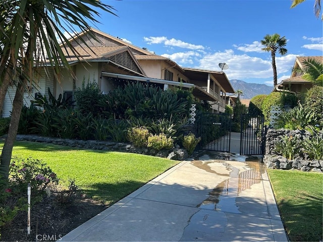 view of property exterior featuring a mountain view and a yard