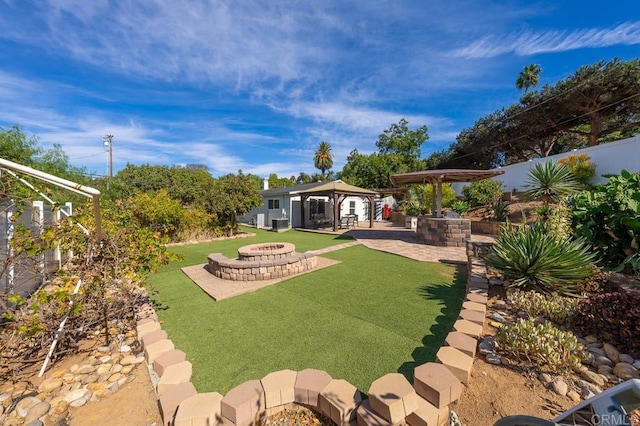 view of yard with a patio, an outdoor structure, a gazebo, and a fire pit