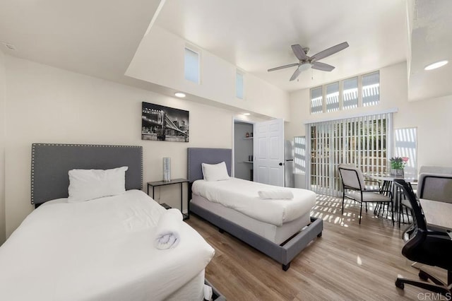 bedroom featuring hardwood / wood-style floors and a high ceiling