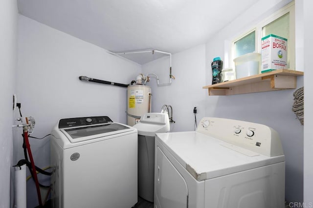 laundry area with washer and dryer and water heater