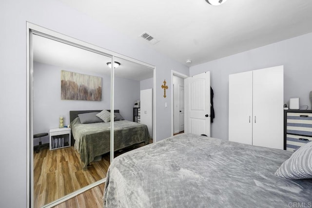 bedroom with hardwood / wood-style floors and a closet