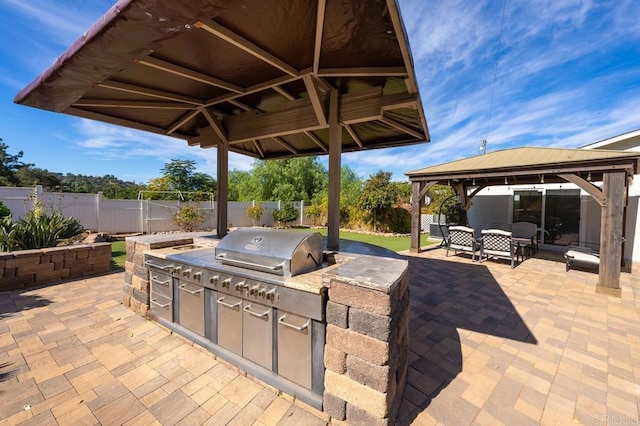 view of patio featuring area for grilling, a gazebo, and an outdoor hangout area