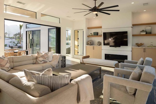 living room featuring built in features and ceiling fan