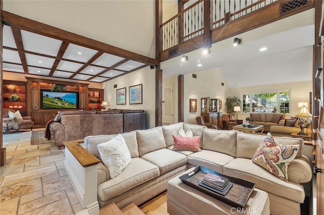 living room with beamed ceiling, a towering ceiling, and coffered ceiling