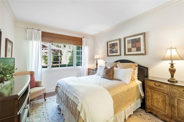 bedroom with ornamental molding and light hardwood / wood-style flooring