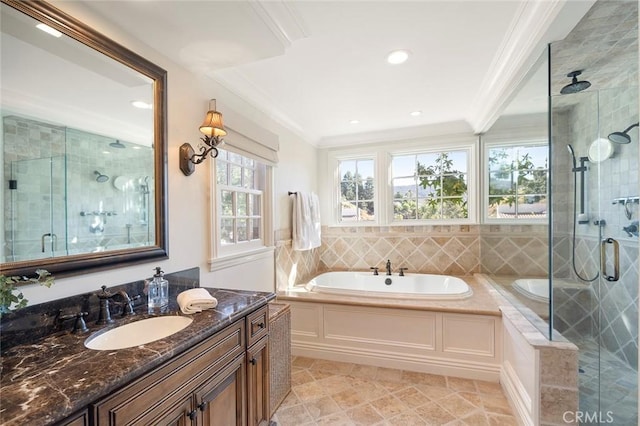 bathroom with vanity, ornamental molding, and plus walk in shower