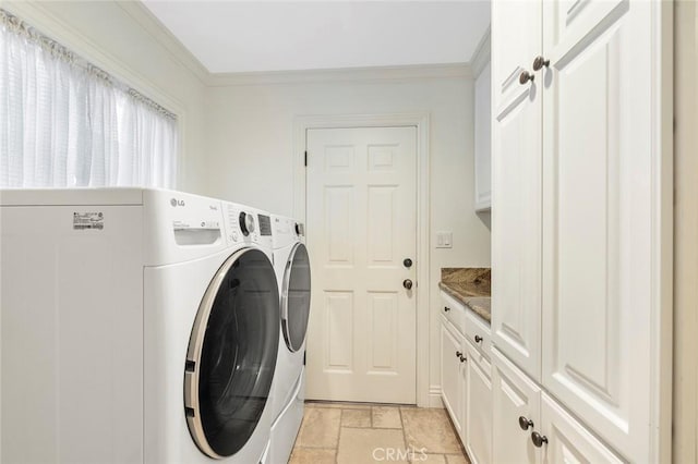 laundry room with crown molding, cabinets, and washing machine and clothes dryer