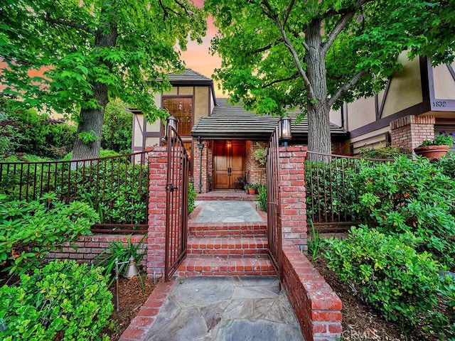 view of exterior entry at dusk