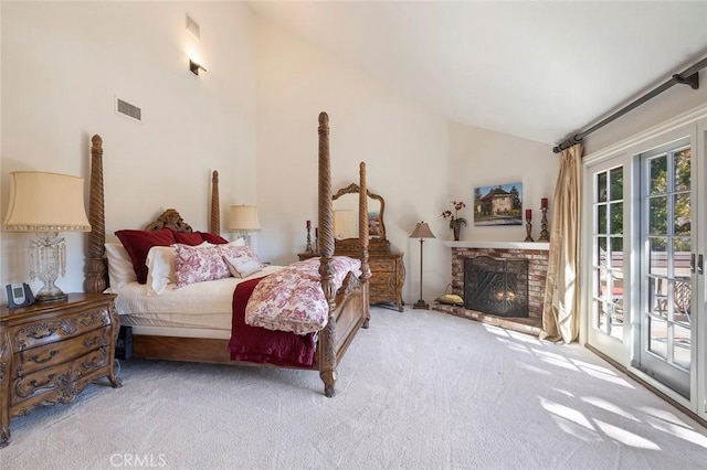 bedroom with light colored carpet, lofted ceiling, and access to exterior