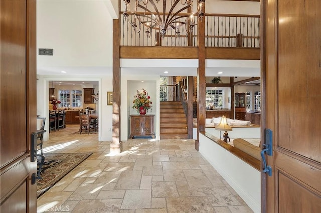 foyer entrance featuring a towering ceiling