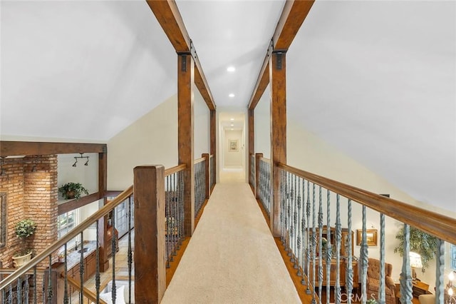 hallway with light carpet and beamed ceiling