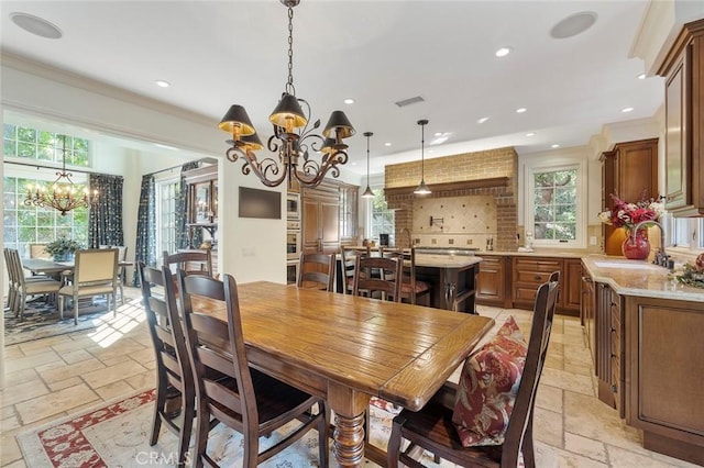 dining space with an inviting chandelier, sink, and a wealth of natural light