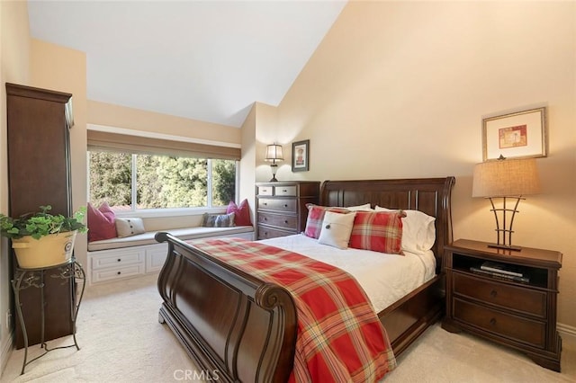 carpeted bedroom featuring lofted ceiling