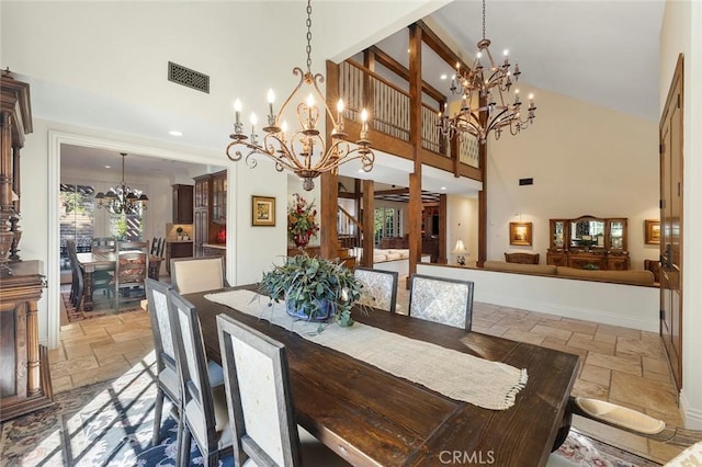 dining space with high vaulted ceiling