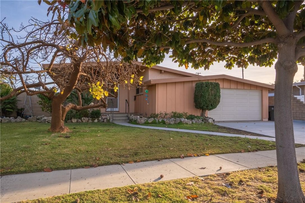 view of front of home with a garage and a front lawn