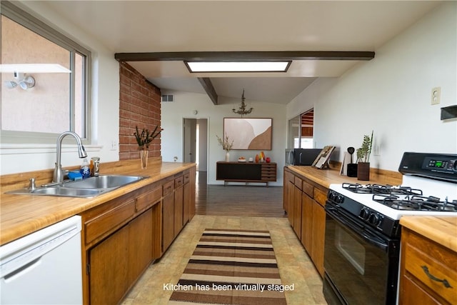 kitchen featuring lofted ceiling with beams, white appliances, sink, and an inviting chandelier