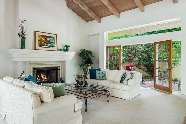 carpeted living room with wood ceiling, high vaulted ceiling, and beamed ceiling