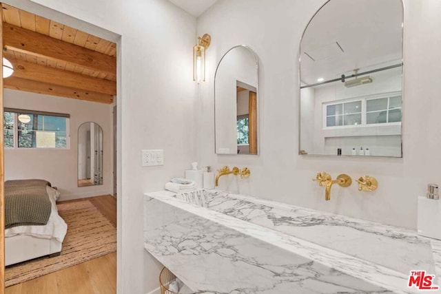 bathroom with beamed ceiling, wooden ceiling, and hardwood / wood-style floors