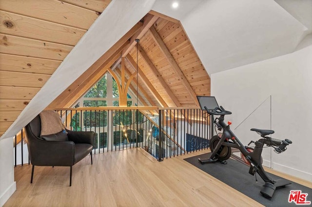 exercise area with wood-type flooring, vaulted ceiling, and wood ceiling