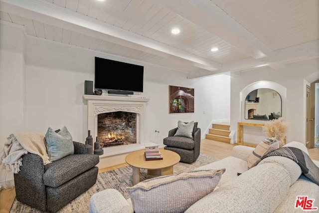 living room featuring beam ceiling and light wood-type flooring