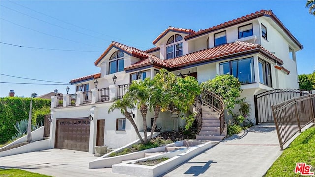 mediterranean / spanish house with a balcony and a garage