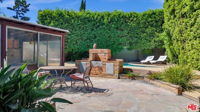 view of patio / terrace with an outdoor stone fireplace