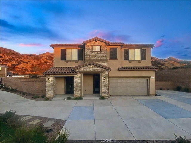 mediterranean / spanish-style house featuring a mountain view and a garage