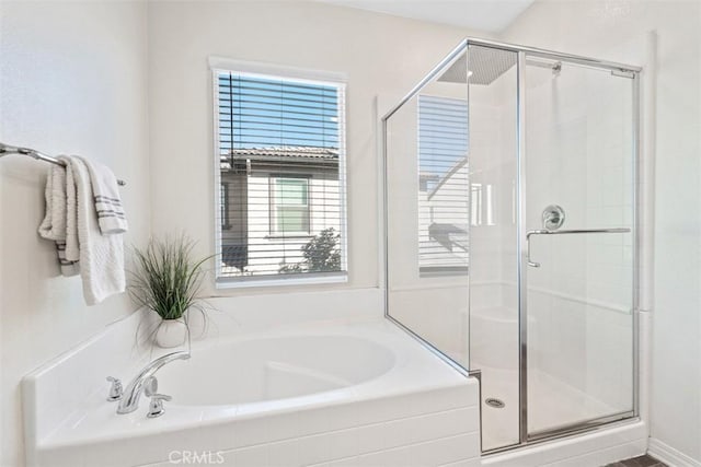 bathroom with separate shower and tub