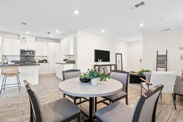 dining room with sink and light hardwood / wood-style flooring